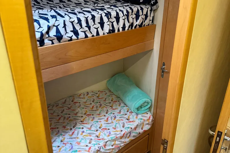 Slide: The Image of Bunk beds in the 1999 Bertram 60 Convertible yacht cabin. - 47