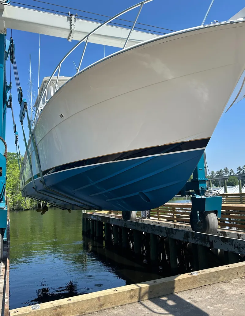 Slide: The Image of 1999 Bertram 60 Convertible boat being lifted out of the water. - 8