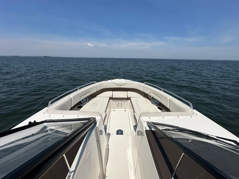 Slide: The Image of 2014 Chaparral 307 SSX boat on open water under clear blue sky. - 10