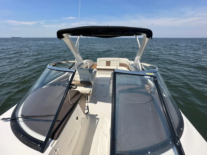 Slide: The Image of 2014 Chaparral 307 SSX boat on open water with clear skies. - 11