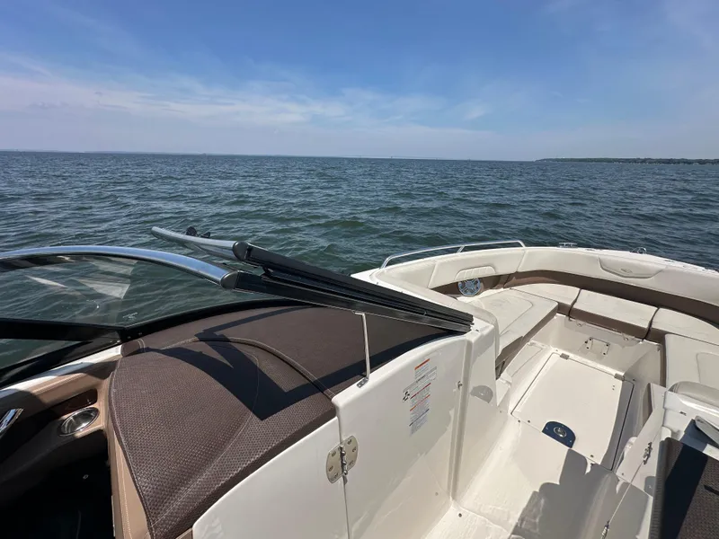 Slide: The Image of 2014 Chaparral 307 SSX boat on open water under clear blue sky. - 12