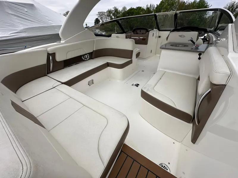 Slide: The Image of 2014 Chaparral 307 SSX boat interior with white and brown seating. - 17