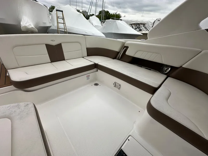 Slide: The Image of 2014 Chaparral 307 SSX boat interior with white and brown seating. - 19
