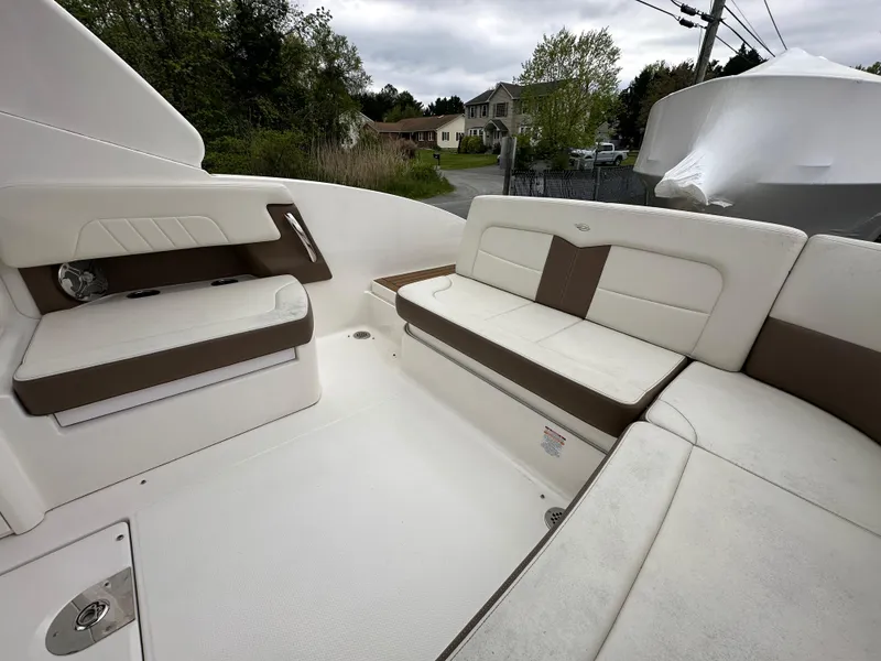 Slide: The Image of 2014 Chaparral 307 SSX boat interior with white and brown seating. - 20