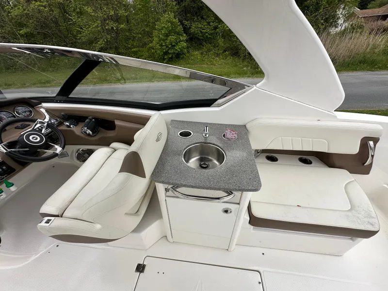 Slide: The Image of Interior of 2014 Chaparral 307 SSX boat with helm, seating, and sink. - 21