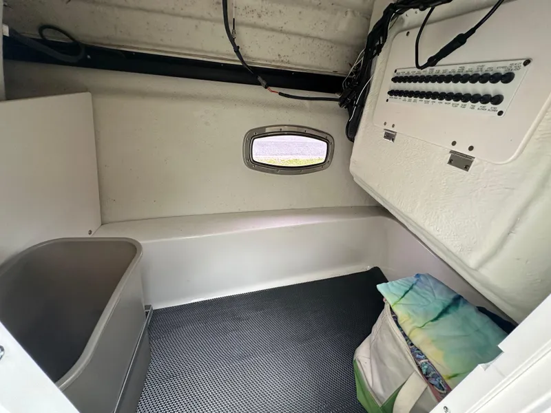 Slide: The Image of Interior cabin of a 2014 Chaparral 307 SSX boat with storage and control panel. - 26