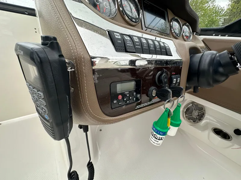 Slide: The Image of Control panel of a 2014 Chaparral 307 SSX boat with keys and radio. - 27