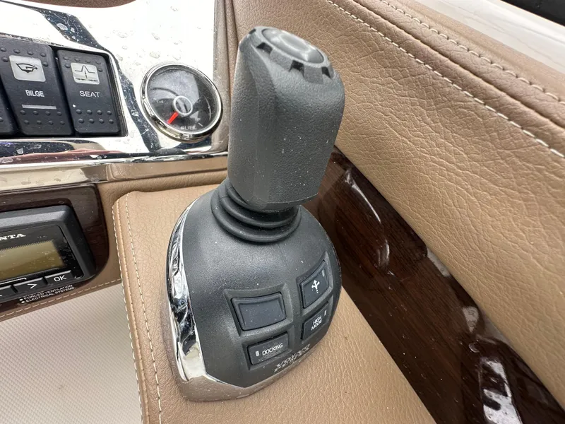 Slide: The Image of Close-up of the control panel and joystick of a 2014 Chaparral 307 SSX boat. - 3