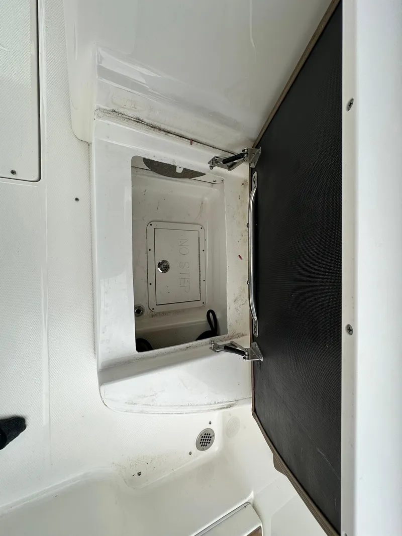 Slide: The Image of Open storage compartment on a 2014 Chaparral 307 SSX boat. - 31