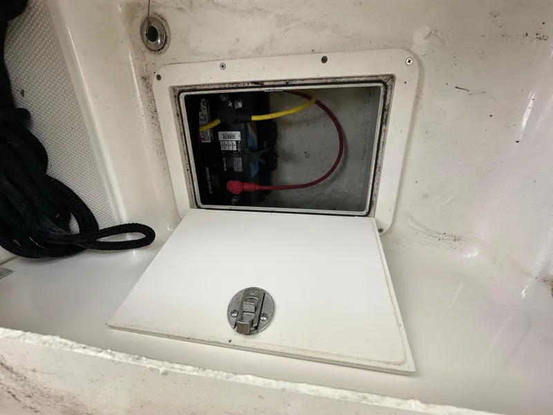 Slide: The Image of Battery compartment of a 2014 Chaparral 307 SSX boat with open hatch. - 33