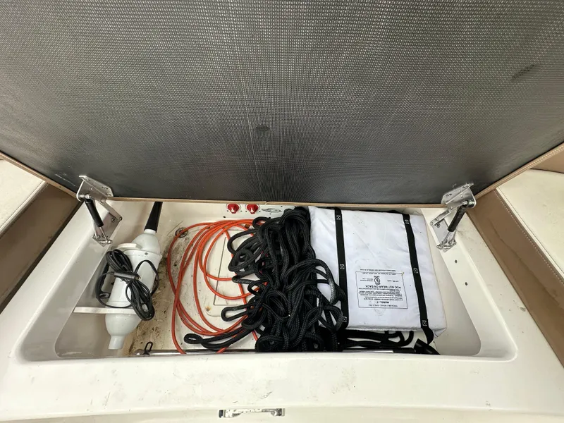 Slide: The Image of Storage compartment of a 2014 Chaparral 307 SSX boat with ropes and equipment. - 34