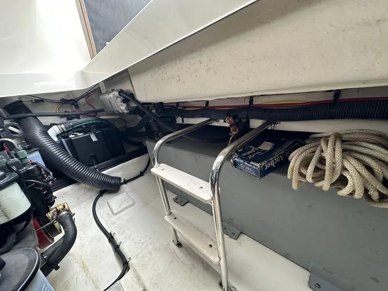 Slide: The Image of Engine compartment of a 2014 Chaparral 307 SSX boat with ladder and coiled rope. - 42
