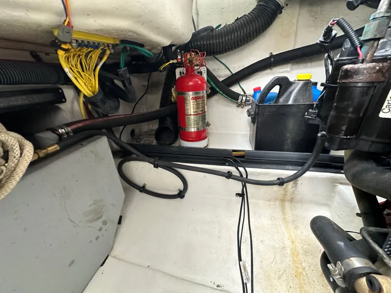Slide: The Image of Engine compartment of a 2014 Chaparral 307 SSX boat with fire extinguisher and wiring. - 43