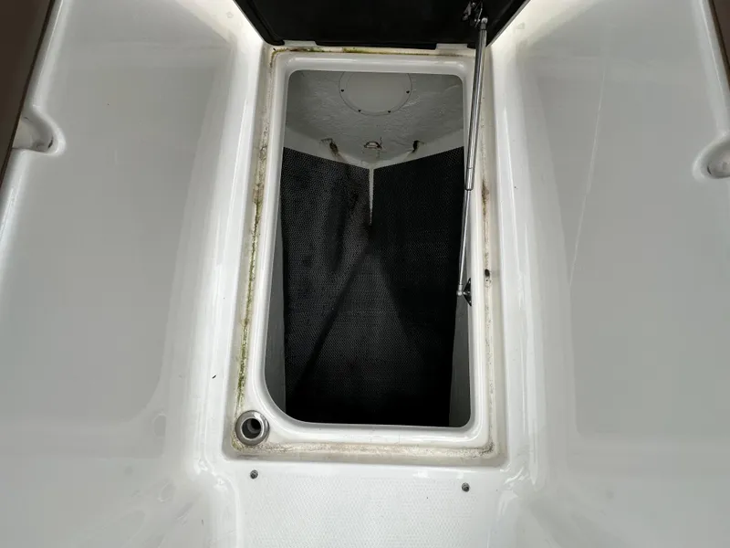Slide: The Image of Open storage compartment on a 2014 Chaparral 307 SSX boat. - 46