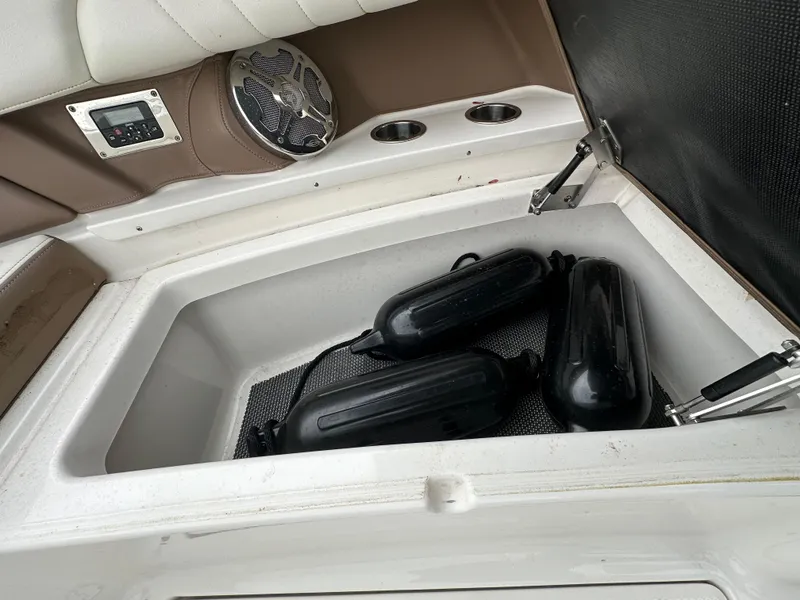 Slide: The Image of Storage compartment of a 2014 Chaparral 307 SSX boat with black fenders. - 47