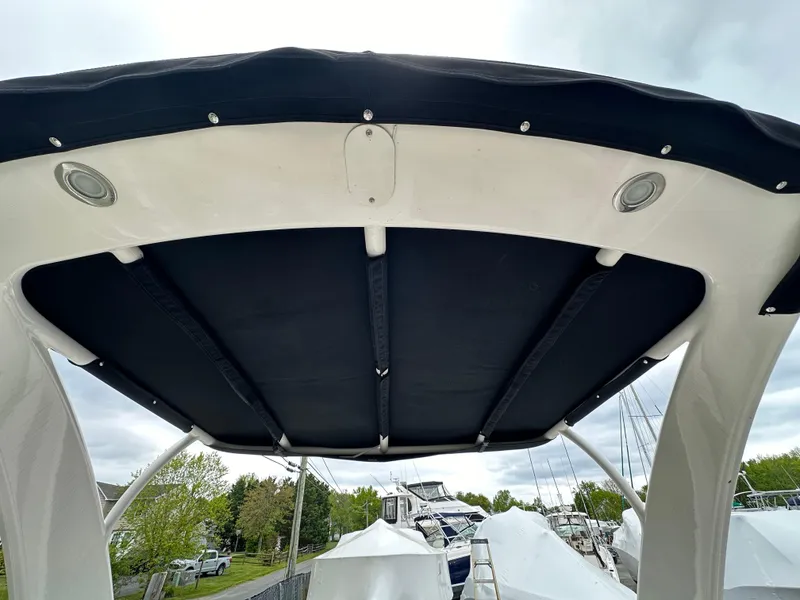 Slide: The Image of 2014 Chaparral 307 SSX boat canopy with black cover and white frame. - 49