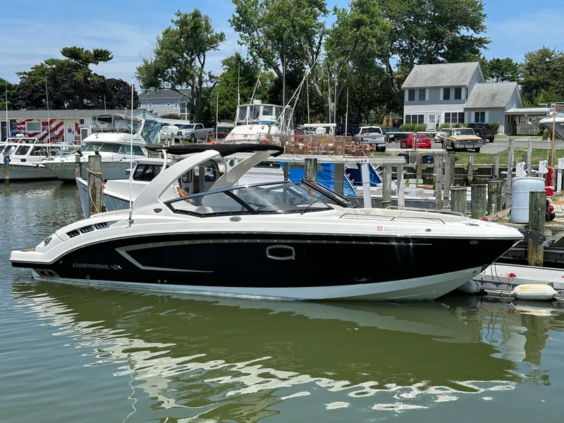 Slide: The Image of 2014 Chaparral 307 SSX boat docked at a marina. - 51