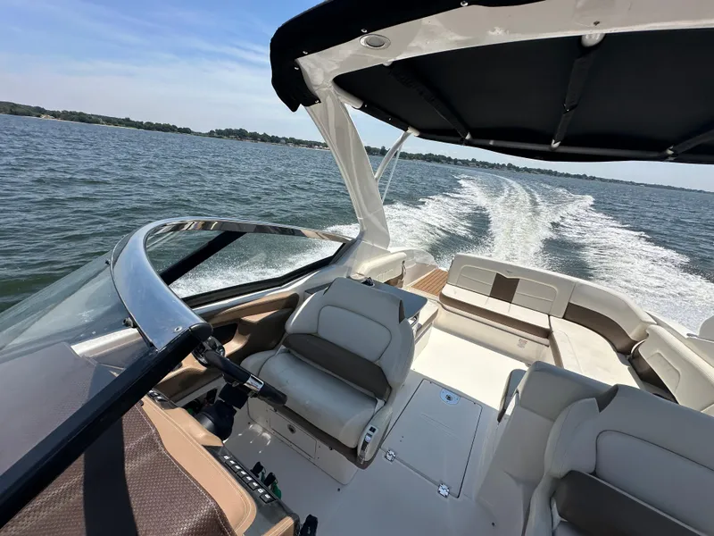 Slide: The Image of 2014 Chaparral 307 SSX boat cruising on a lake, interior view. - 7