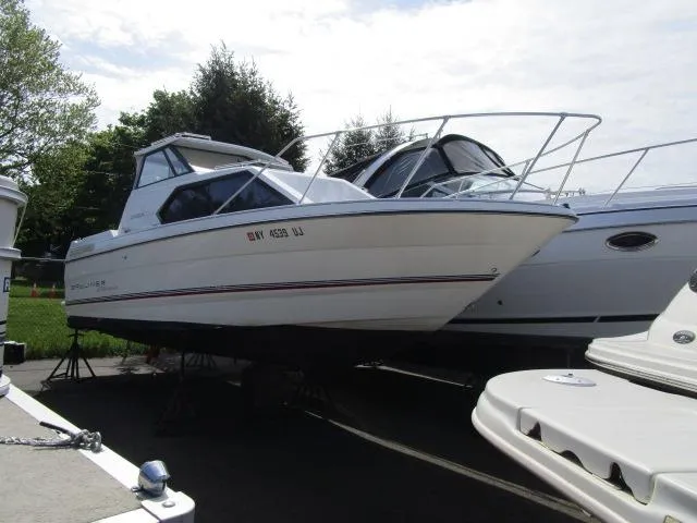 The Image of 1994 Bayliner 2452 Classic boat on stands in a marina. - 1