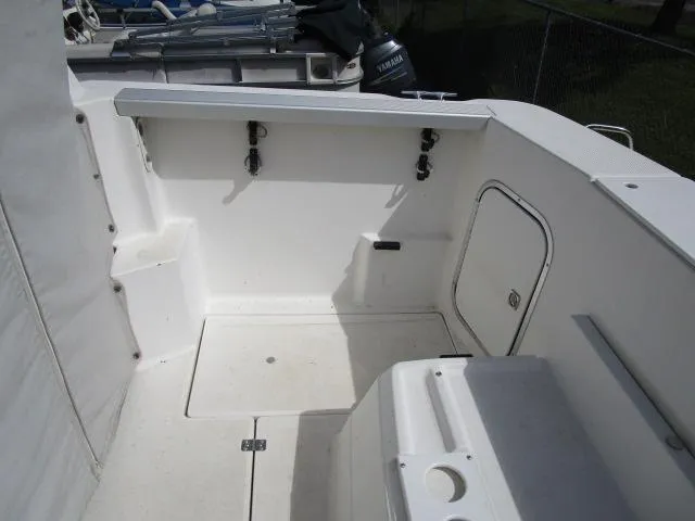 Slide: The Image of 1994 Bayliner 2452 Classic boat deck with storage compartments and rod holders. - 10