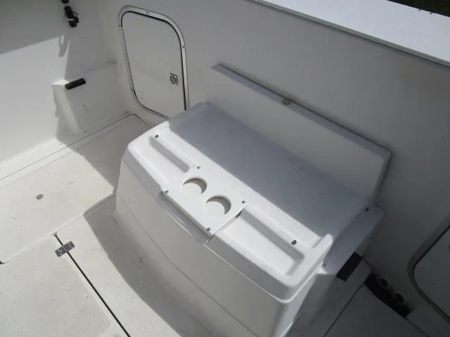 Slide: The Image of 1994 Bayliner 2452 Classic boat interior with storage compartment and cup holders. - 11