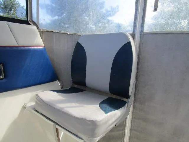 Slide: The Image of 1994 Bayliner 2452 Classic boat interior seat with blue and white upholstery. - 7