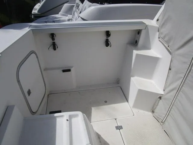Slide: The Image of 1994 Bayliner 2452 Classic boat interior with white seating and storage compartments. - 9