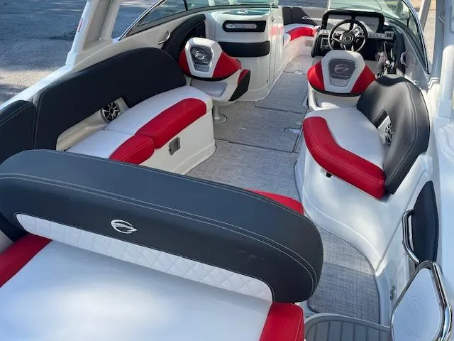 Slide: The Image of 2024 Crownline 290 SS boat interior with red, black, and white seating. - 2