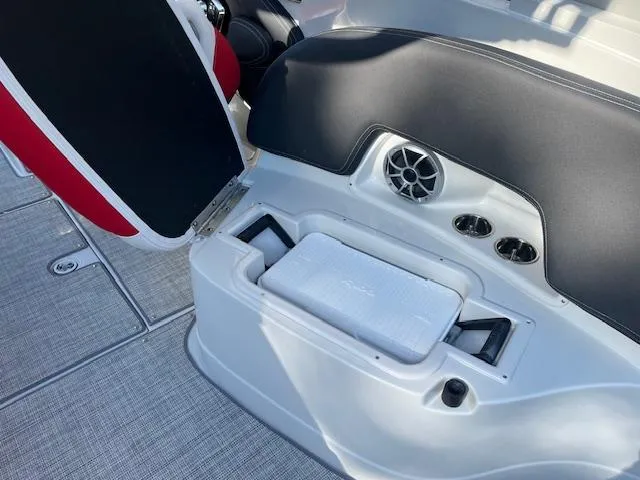 Slide: The Image of 2024 Crownline 290 SS boat interior with built-in cooler and speaker. - 3