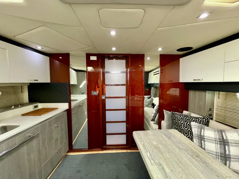 Slide: The Image of Interior of 2009 Sea Ray 470 Sundancer yacht with modern kitchen and dining area. - 13
