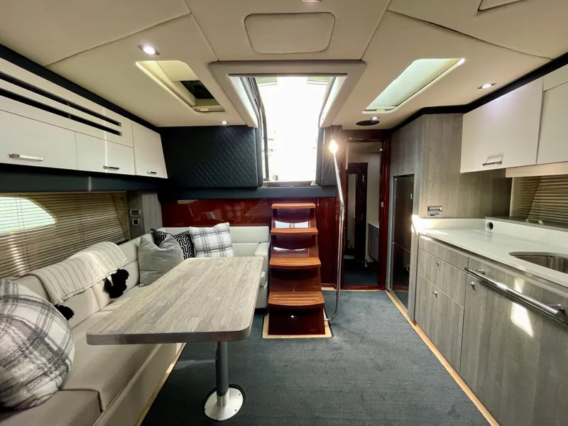Slide: The Image of Interior of 2009 Sea Ray 470 Sundancer yacht with modern kitchen and dining area. - 16