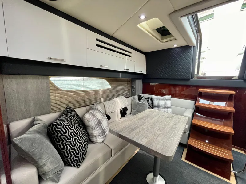 Slide: The Image of Interior of 2009 Sea Ray 470 Sundancer with modern seating and dining area. - 17