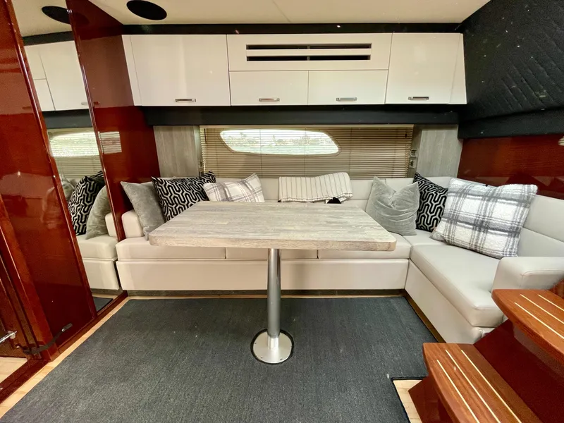 Slide: The Image of Interior of 2009 Sea Ray 470 Sundancer with modern seating and dining area. - 18