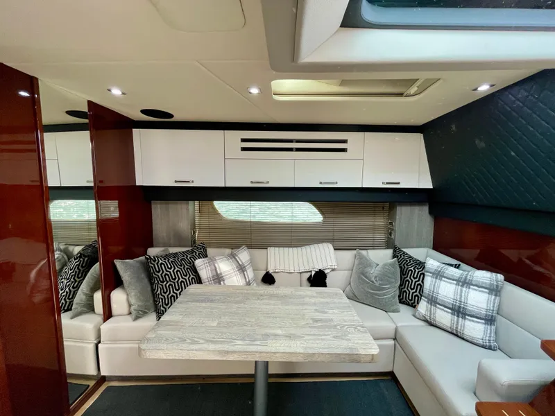 Slide: The Image of 2009 Sea Ray 470 Sundancer interior with modern seating and dining area. - 19