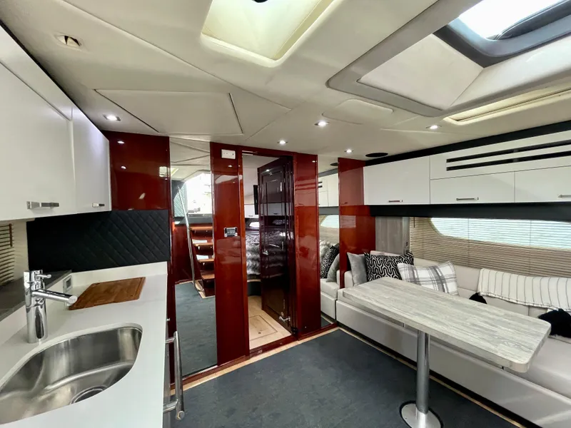 Slide: The Image of Luxurious interior of a 2009 Sea Ray 470 Sundancer yacht with modern kitchen and seating area. - 20