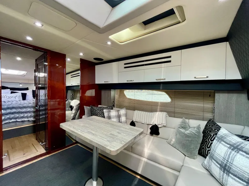 Slide: The Image of Luxurious interior of 2009 Sea Ray 470 Sundancer yacht with modern seating and dining area. - 21