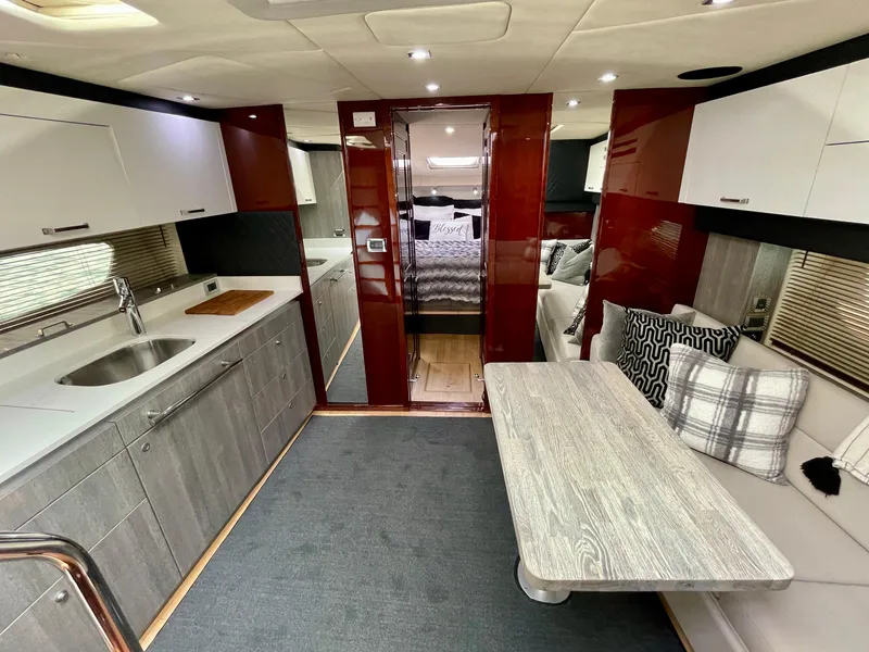Slide: The Image of Interior of 2009 Sea Ray 470 Sundancer yacht with modern kitchen and dining area. - 22