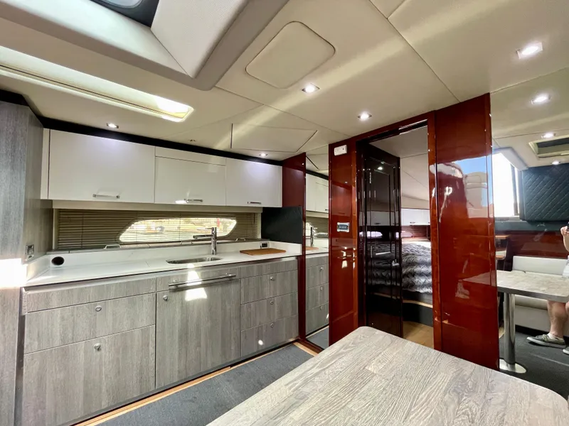 Slide: The Image of Interior of 2009 Sea Ray 470 Sundancer yacht with modern kitchen and dining area. - 23