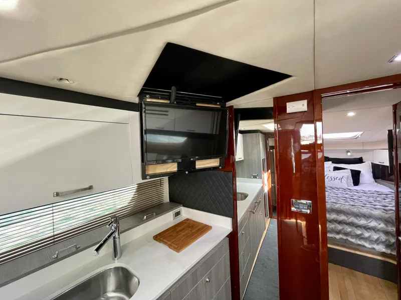 Slide: The Image of Interior of 2009 Sea Ray 470 Sundancer yacht with modern kitchen and cozy bedroom. - 26