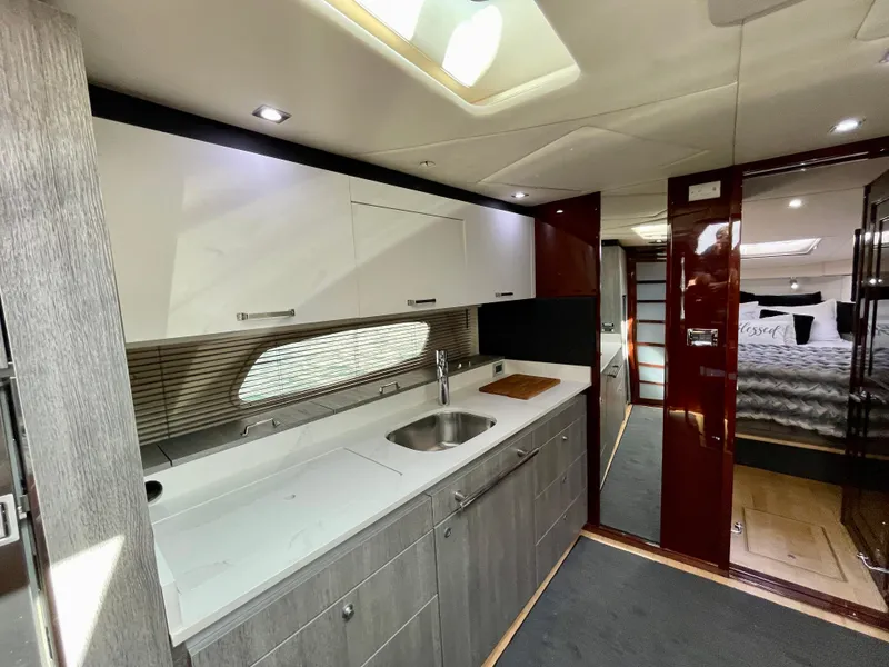 Slide: The Image of 2009 Sea Ray 470 Sundancer yacht interior kitchen with modern cabinetry and sink. - 27