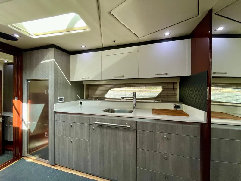 Slide: The Image of Modern kitchen area in 2009 Sea Ray 470 Sundancer yacht with sleek cabinetry and skylight. - 30