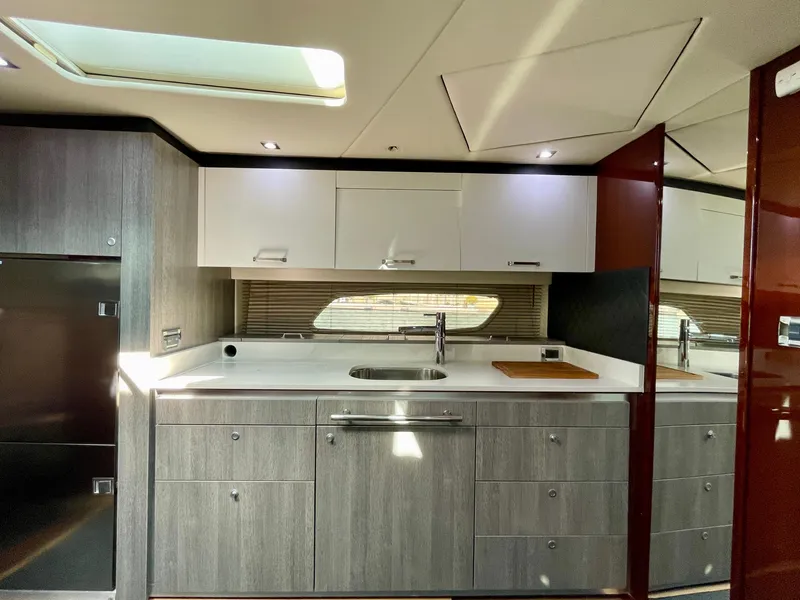 Slide: The Image of Modern kitchen area in 2009 Sea Ray 470 Sundancer yacht with sleek cabinetry and stainless steel fixtures. - 31
