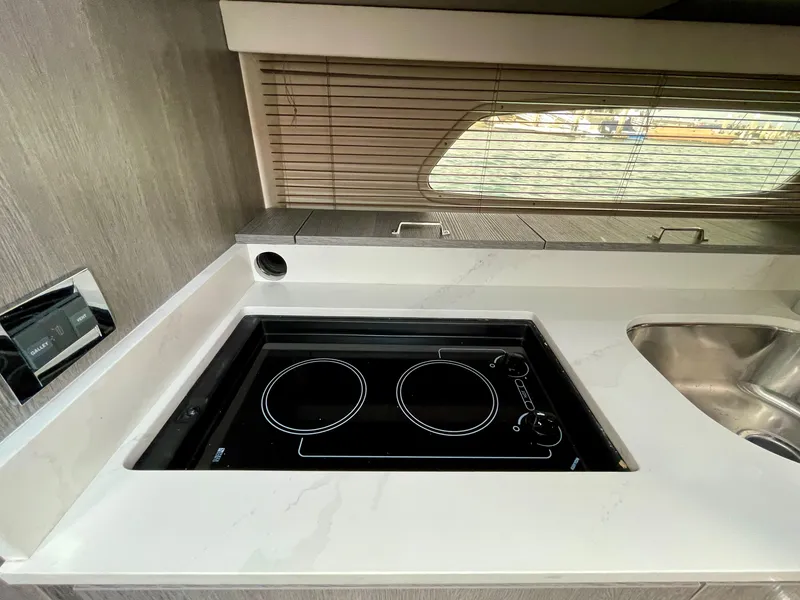 Slide: The Image of Modern kitchen area in a 2009 Sea Ray 470 Sundancer yacht with stovetop and sink. - 34