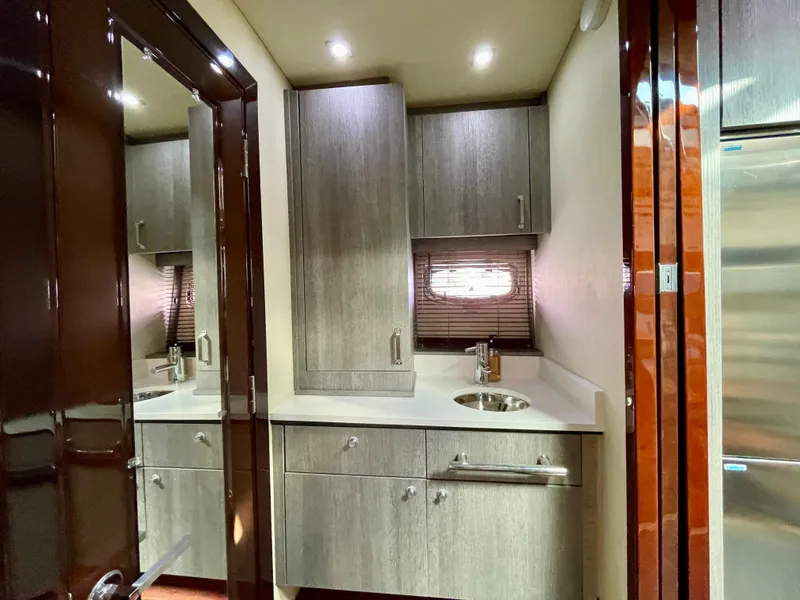 Slide: The Image of Modern kitchen area in 2009 Sea Ray 470 Sundancer yacht with sleek cabinetry and stainless steel sink. - 40