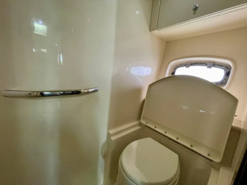 Slide: The Image of 2009 Sea Ray 470 Sundancer bathroom with toilet and window. - 41