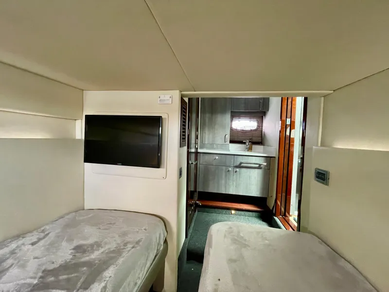 Slide: The Image of Interior cabin of a 2009 Sea Ray 470 Sundancer yacht with twin beds and a TV. - 43