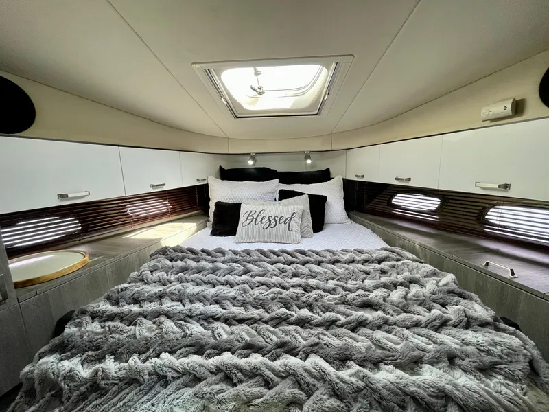 Slide: The Image of Luxurious bedroom interior of 2009 Sea Ray 470 Sundancer yacht with cozy bedding. - 45