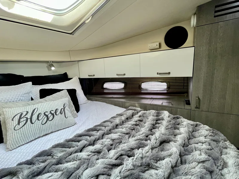 Slide: The Image of Luxurious bedroom interior of 2009 Sea Ray 470 Sundancer yacht with cozy bedding. - 47