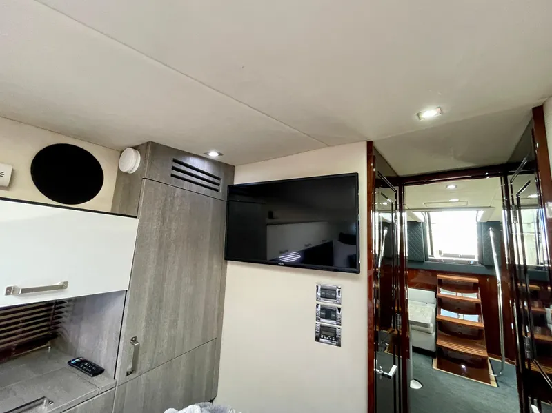 Slide: The Image of Interior of 2009 Sea Ray 470 Sundancer with TV and modern cabinetry. - 48
