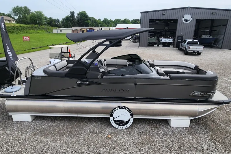 Slide: The Image of 2024 Avalon Windshield Catalina 2585 pontoon boat displayed at a marina. - 23